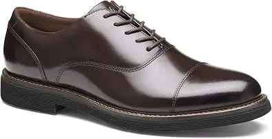 Dark brown leather cap-toe oxford dress shoe shown from a three-quarter front angle, featuring lace-up closure with matching brown laces, visible stitching along the welt, and a ribbed dark rubber outsole.