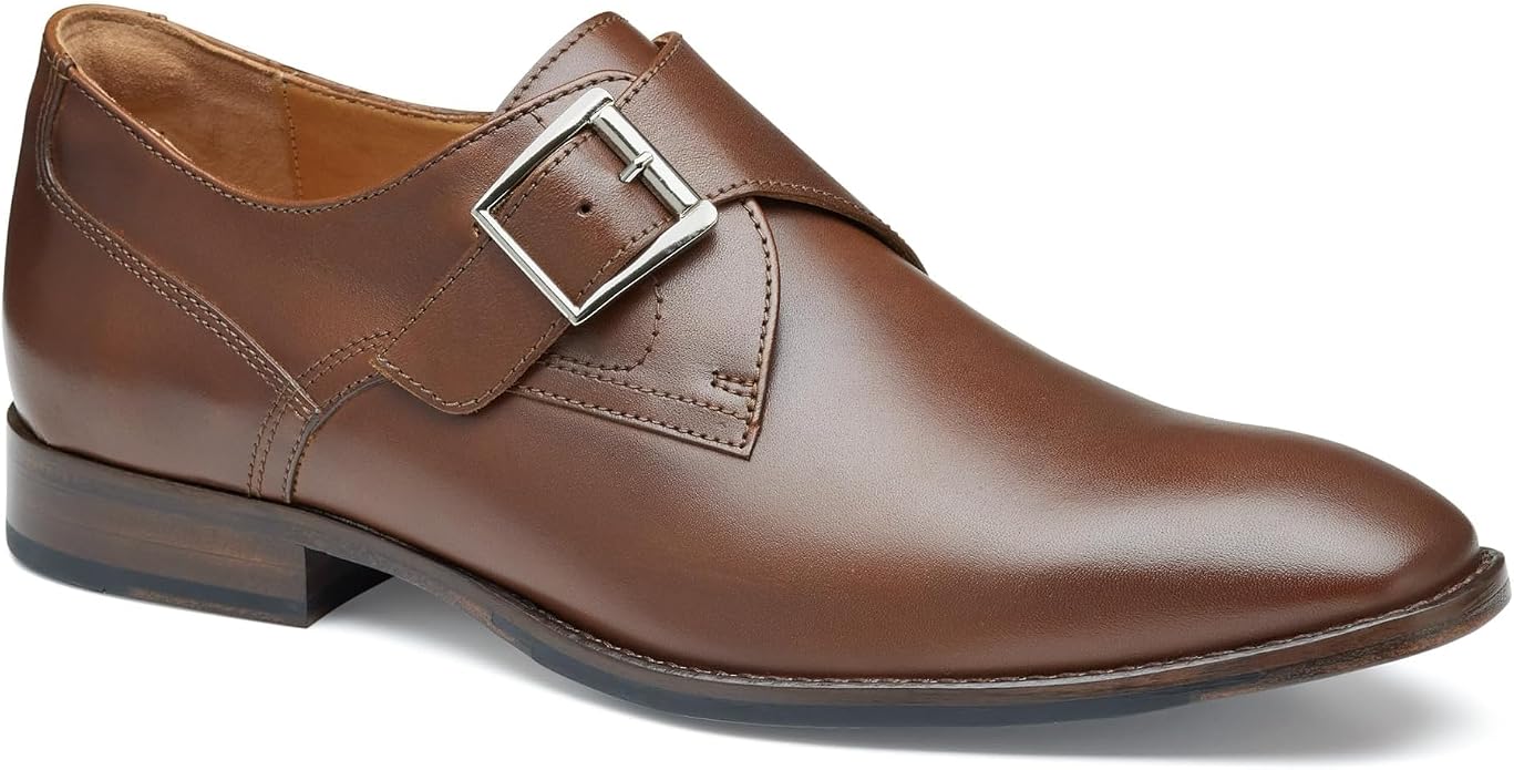 Brown leather single monk strap dress shoe shown in three-quarter view, featuring a silver rectangular buckle closure, pointed toe, low stacked heel, and tan leather interior lining visible at the collar.