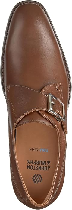 Top-down view of a tan leather monk strap dress shoe with a single silver-toned buckle strap across the vamp. Interior insole reads 'TruFoam' and 'Johnston & Murphy' with the brand logo.
