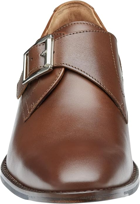 Front view of a brown leather monk strap dress shoe with a single silver-toned rectangular buckle strap across the vamp, smooth glossy upper, tan interior lining visible at the collar, and a thin outsole.